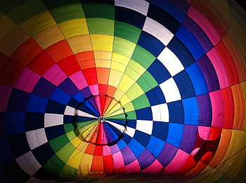 Vibrant interior shot of a colorful hot air balloon, showcasing its rainbow pattern and design. HD wallpaper