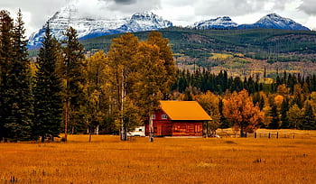 que cabin nestled in autumn landscape with mountain backdrop, ideal for serene retreats. HD wallpaper