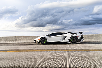 Lamborghini — White Supercar on Coastal Highway HD wallpaper