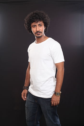 Portrait of a fashionable man in casual attire against a dark background, showcasing modern style. HD phone wallpaper