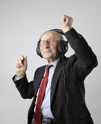 Senior man enjoying music with heads, expressing happiness and energy. HD phone wallpaper