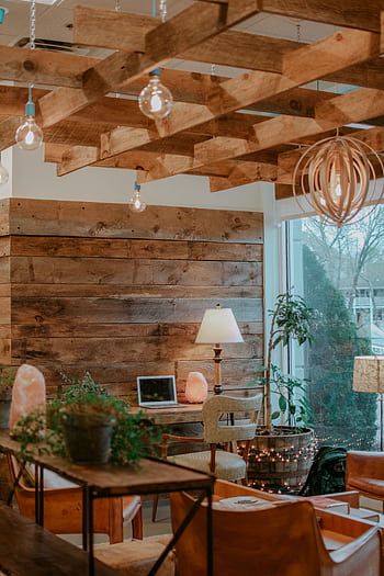 A warmly lit living room featuring rustic wooden decor, modern furniture, and natural light. HD phone wallpaper