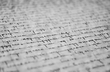 Close-up of vintage handwritten text on old paper, showcasing detailed penmanship and texture. HD wallpaper