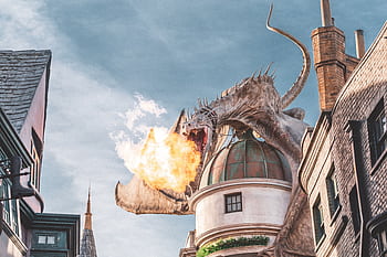 Epic fire-breathing dragon atop building at Universal Studios, Orlando. HD wallpaper