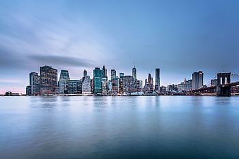 Stunning view of the New York City skyline and Brooklyn Bridge at dusk. HD wallpaper