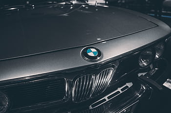 Close-up of classic BMW hood showcasing emblem and chrome details. Captured in Munich, Germany. HD wallpaper