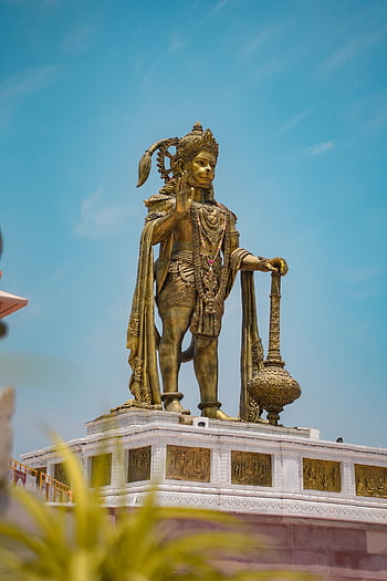 Stunning low angle view of the Hanuman statue in Ahmedabad, showcasing ornate details against a clear blue sky. HD phone wallpaper