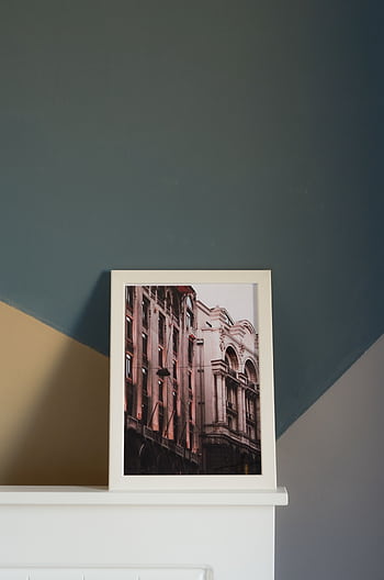 Framed of elegant architecture resting on a modern mantelpiece indoors. HD phone wallpaper