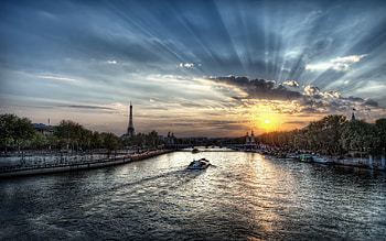 Sunset In Paris, rays, boat, colors, peaceful, boats, trees, sunset, france, eiffel tower, view, nature, romantic, lovely, river, colorful, ship, sunlight, beauty, buildings, reflection, road, water, architecture, city, paris, beautiful, romance, ships, bridge, building, clouds, alley, sky HD wallpaper