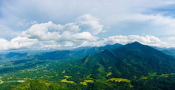 An expansive view of verdant mountains and valleys under a bright sky in Kegalle, Sri Lanka. HD wallpaper