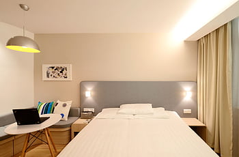 Contemporary hotel room with minimalist interior design and cozy lighting. HD wallpaper