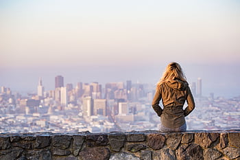 A woman overlooks the stunning skyline of San Francisco at daylight, capturing the city's urban beauty. HD wallpaper