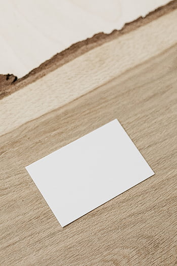 Minimalist blank business card placed on a textured wooden surface with ample copy space. HD phone wallpaper