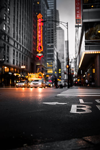 Dynamic cityscape at night with illuminated signs, streetlights, and a bustling intersection. HD phone wallpaper