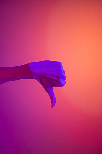 A hand showing a thumbs down sign with vibrant neon purple and orange lighting. HD phone wallpaper