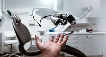 Floating dental loupes in a modern, clean dentist office setting. HD wallpaper
