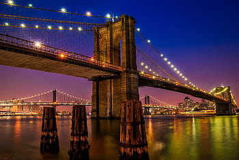 Stunning evening view of the illuminated Brooklyn Bridge in New York City. HD wallpaper