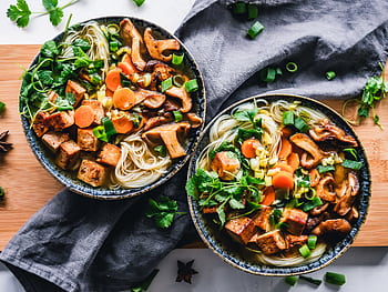 A vibrant noodle bowl with tofu, mushrooms, and fresh vegetables, perfect for a healthy meal. HD wallpaper