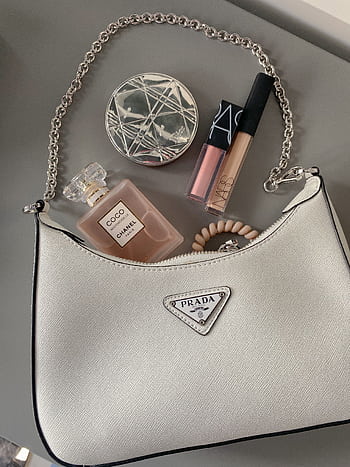 Elegant flatlay featuring a luxury handbag with makeup and perfume. HD phone wallpaper