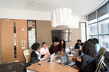 Group of professionals engaged in a strategic meeting in a modern office setting. HD wallpaper
