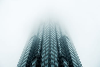 Low angle view of a modern skyscraper disappearing into fog in Atlanta, GA. HD wallpaper