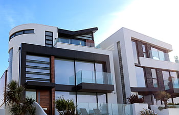Contemporary luxury home with glass balconies in Poole, UK, showcasing modern architectural design. HD wallpaper
