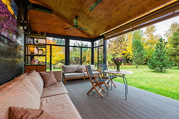 Elegant modern porch with comfortable seating and vibrant garden view. HD wallpaper