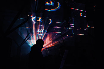 A man standing in a dark clubroom illuminated by muted strobing lights, lights, disco, club, clubbing, strobe, dark, black, room, man, digital, abstract HD wallpaper