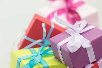 Close-up of vibrant gift boxes with ribbons, perfect for festive occasions. HD wallpaper