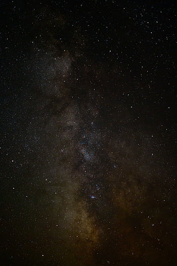 Captivating view of the Milky Way and distant nebula in a starry night sky. HD phone wallpaper