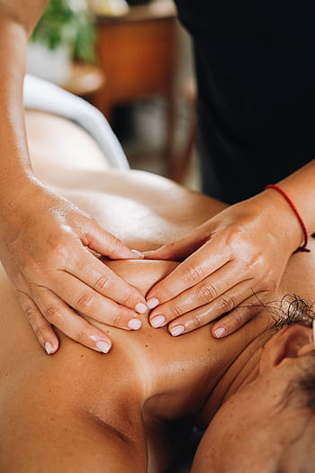 Close-up of a relaxing massage focusing on well-being and wellness in a tranquil spa setting. HD phone wallpaper