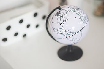 Elegant close-up of a minimalist white globe in a modern indoor setting. HD wallpaper