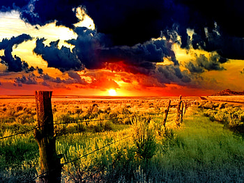 Sunrise over the field, sunshine, beautiful, grass, sunrise, field, green, fence, clouds, nature, sky, dark clouds, sun, sunset HD wallpaper
