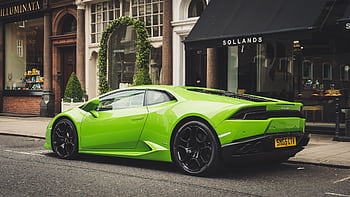 A vibrant lime green Lamborghini parked on a London street, showcasing luxury and style. HD wallpaper