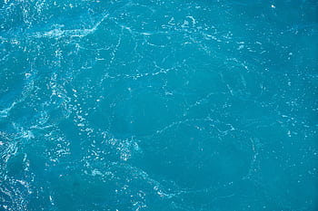 A detailed and vibrant view of turquoise ocean water with light reflections. HD wallpaper