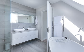 Sleek contemporary bathroom with bathtub and twin sinks, showcasing minimalist design and luxury. HD wallpaper