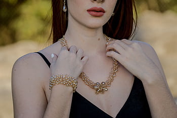 Stylish portrait featuring woman with pearl jewelry including necklace and earrings. HD wallpaper