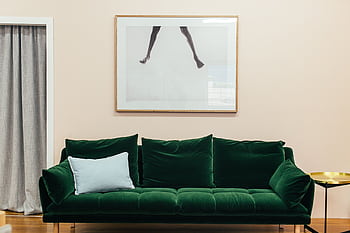 Elegant living room with a green velvet sofa and contemporary decor. HD wallpaper