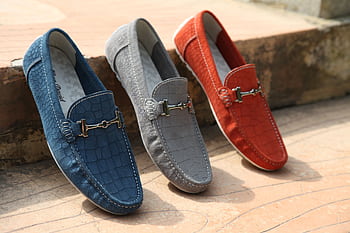 Three colorful leather loafers displayed outdoors showcasing style and elegance. HD wallpaper