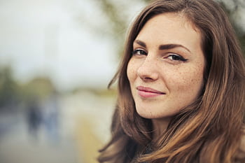 Close-up portrait of a smiling young woman outdoors in Budapest. HD wallpaper