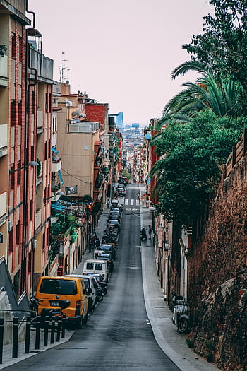 Captivating view of a vibrant street in Barcelona, highlighting urban architecture and everyday life. HD phone wallpaper