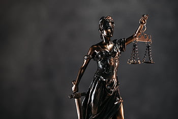 Detailed bronze Lady Justice statue with scales and sword against a dark background, symbolizing law and justice. HD wallpaper