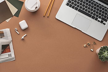 Flat lay of a modern workspace with a laptop, AirPods, and coffee for productivity. HD wallpaper