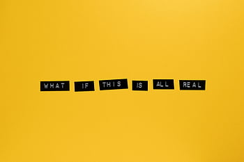 Minimalist text on vibrant yellow backdrop reading 'What if this is all real.' HD wallpaper