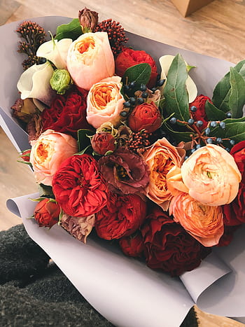 Exquisite arrangement of roses and peonies in a bouquet with lush green leaves and delicate petals. HD phone wallpaper