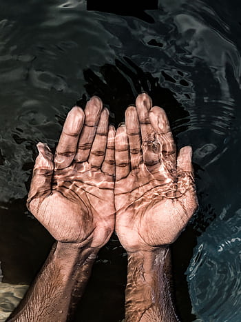 Close-up of hands cupping clear water, representing purity and refreshment. HD phone wallpaper