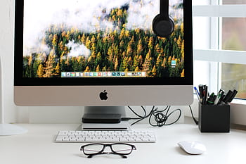 Stylish home office workspace featuring a computer setup with accessories. HD wallpaper