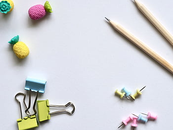Flat lay of vibrant stationery on a clean white background for a creative work environment. HD wallpaper