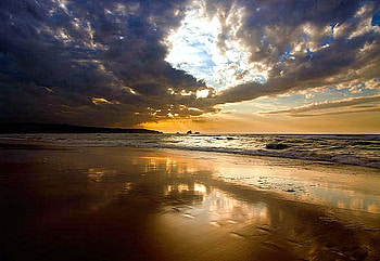 Sunset sands, blue sky, dark clouds, golden sand, reflections, sunset, ocean, beach HD wallpaper