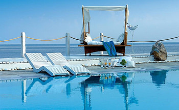 Poolside cabana, blue, cabana, rope, romatic, grapes, reflection, bottles, fruit, candles, pillows, ocean, curtains, mattress, boulder, rock, summer, sunchairs, blanket, pool, bowl, wine HD wallpaper